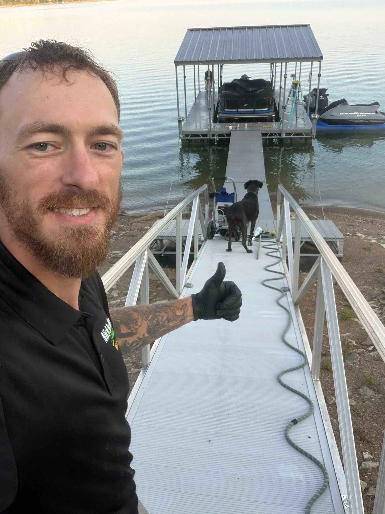 Nick beside a freshly cleaned dock and boat