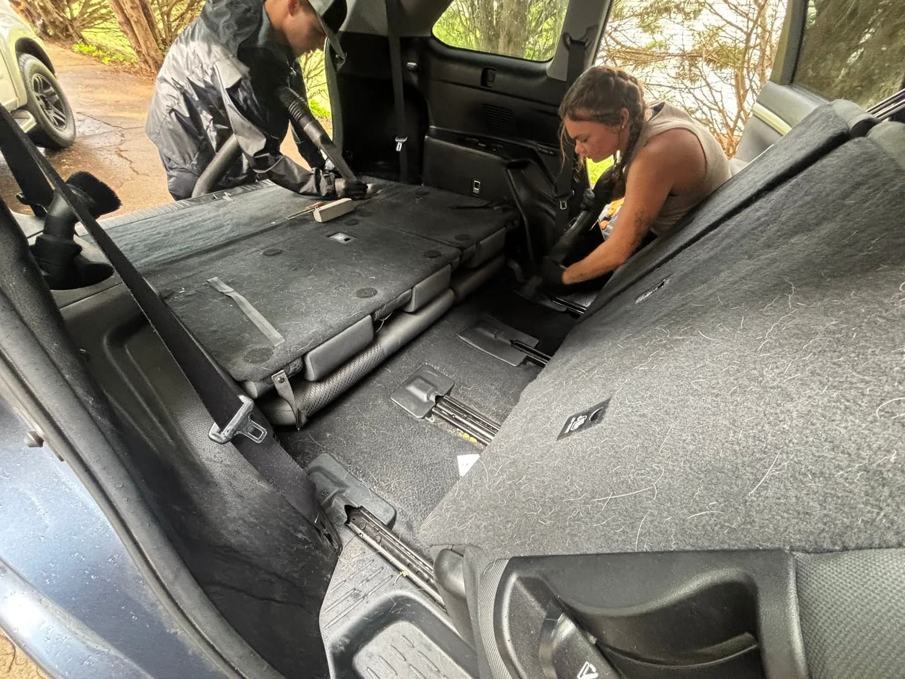 Two people working together on a vehicle interior